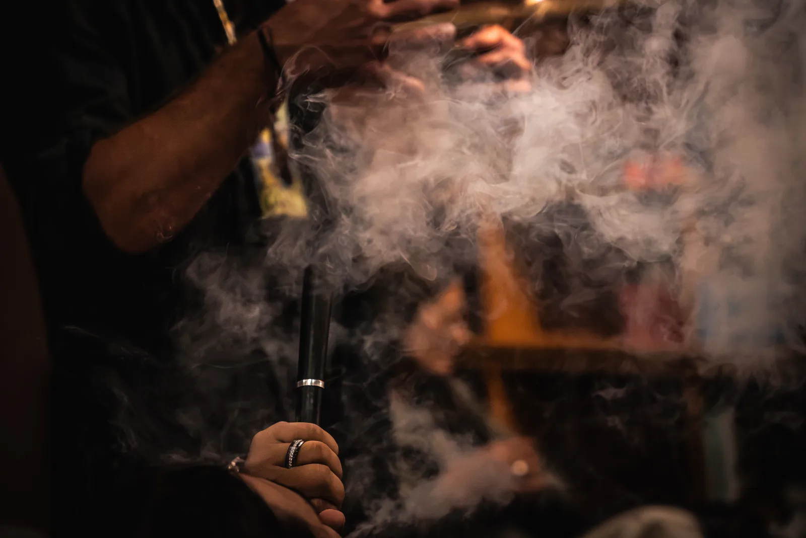 A retreat guest exhaling vapor during an evening session