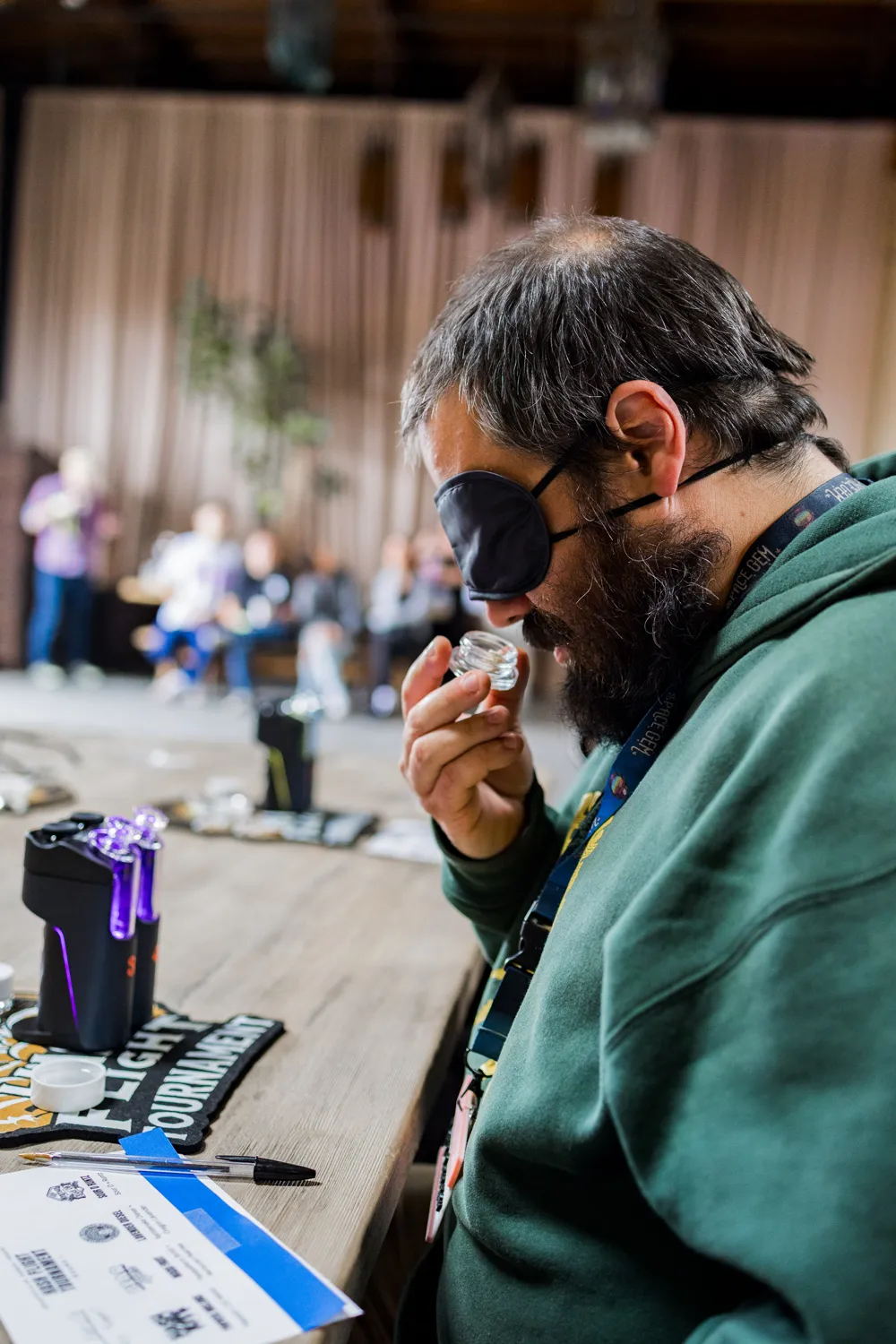 Competitor in an eye mask smelling a sample beside a Dr. Dabber device