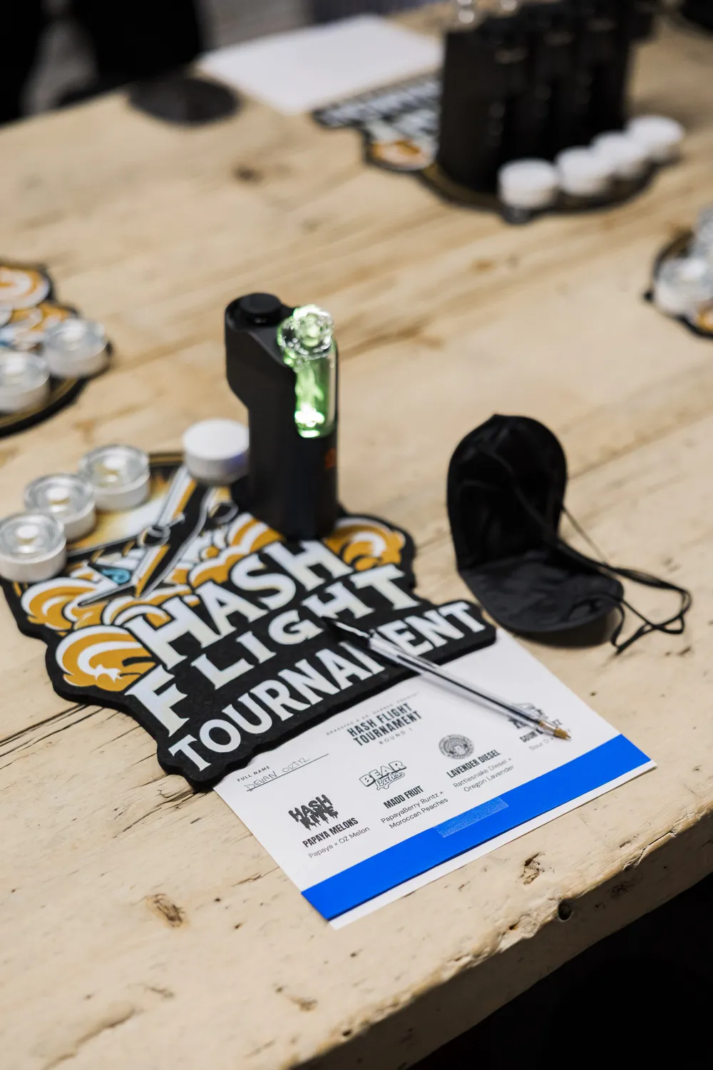 A Flight Manifest, an eye mask and a Dr. Dabber device on the tournament table