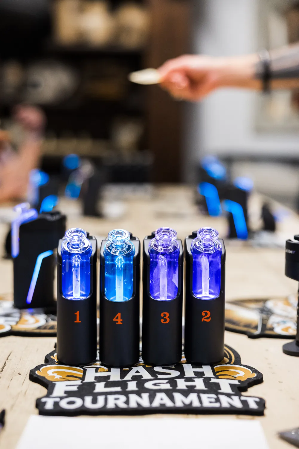 Four numbered samples loaded on Dr. Dabber devices in front of a Hash Flight Tournament mat