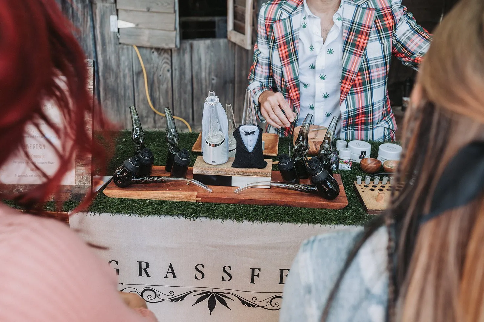 Guests lined up at the Grassfed cannabis bar while the budtender prepares their devices